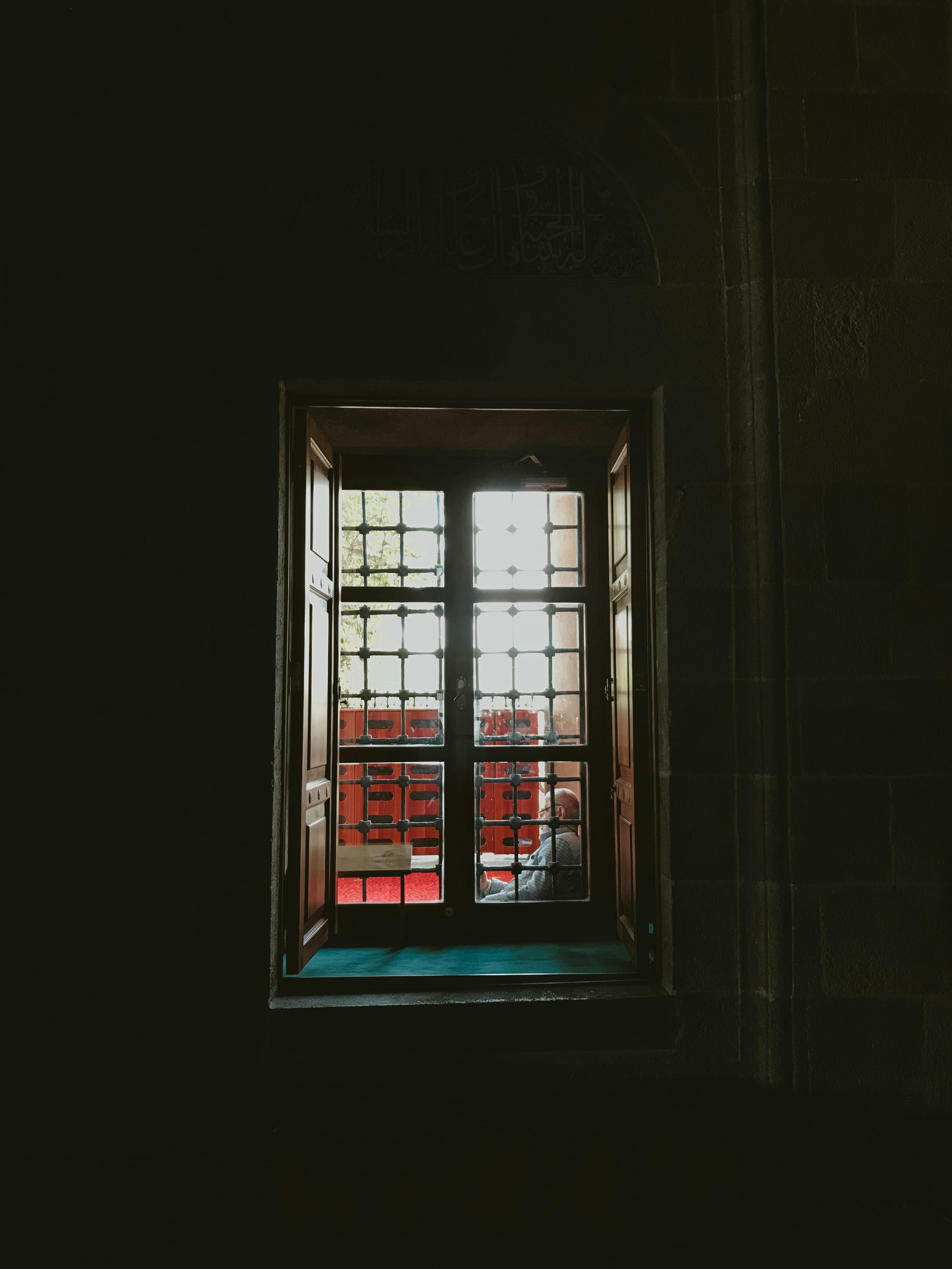 A vintage window casts a silhouette with sunlight streaming through, creating a retro, atmospheric scene.