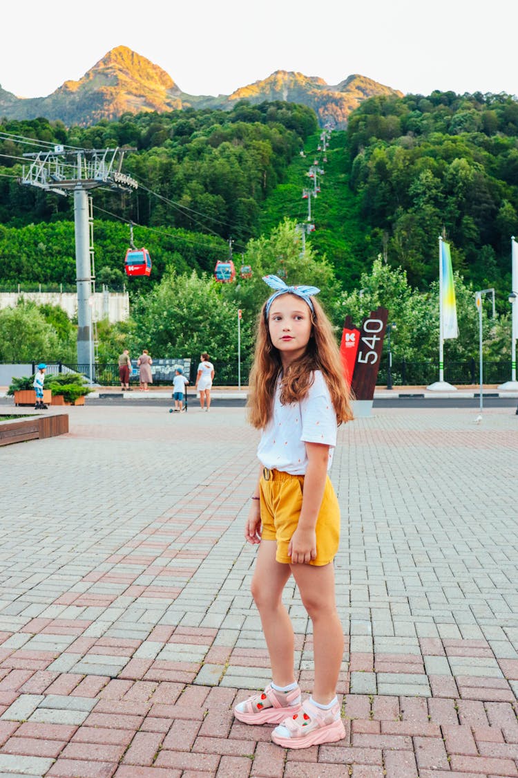 Young Girl Wearing A Bandana Standing On A Park