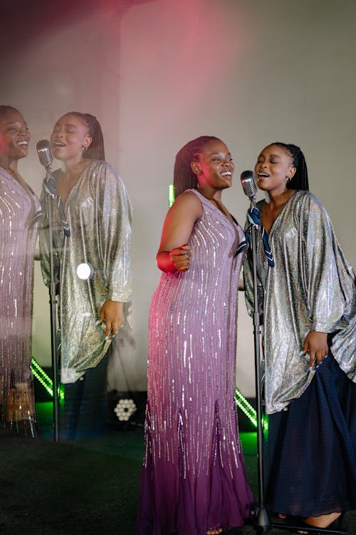 A Pair of Women in Elegant Clothing Singing