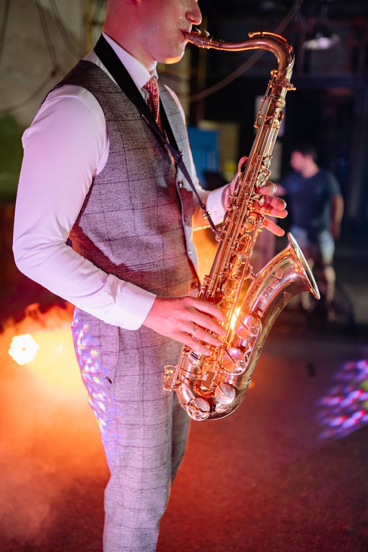 A Person Playing A Saxophone