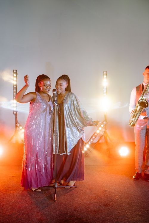 Women Wearing Dresses Singing on Stage · Free Stock Photo