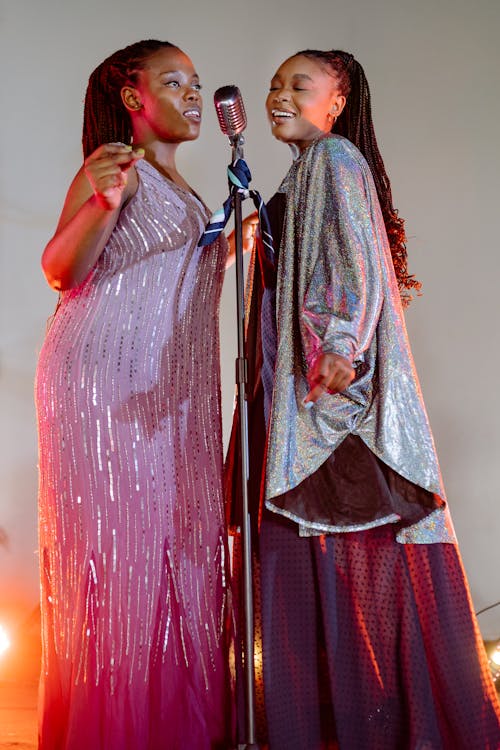 A Pair of Women in Elegant Dresses in a Live Performance