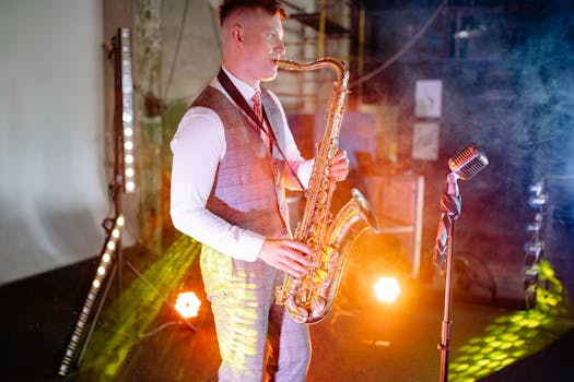A musician plays saxophone in a smoky, illuminated stage setting.