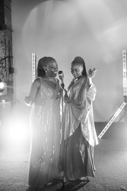 Grayscale Photo of Women Singing