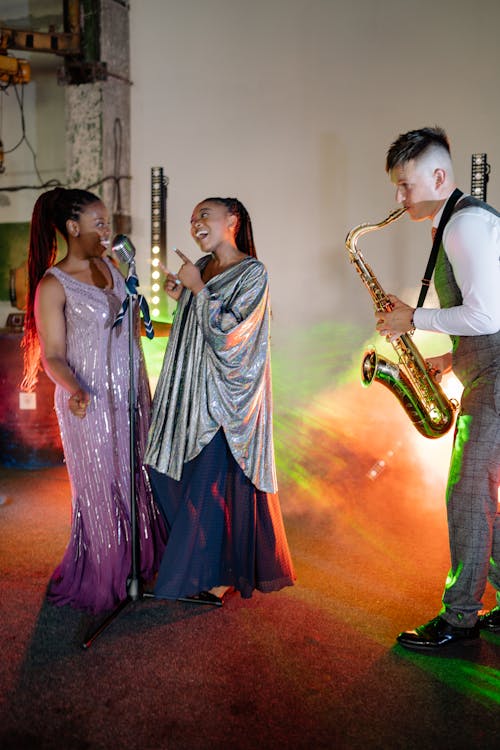Singers and a Saxophonist Performing on Stage