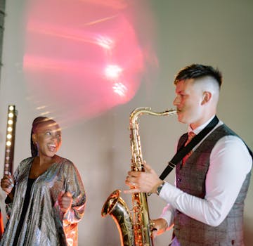 A lively jazz performance featuring a saxophonist and a singer with dramatic stage lighting.