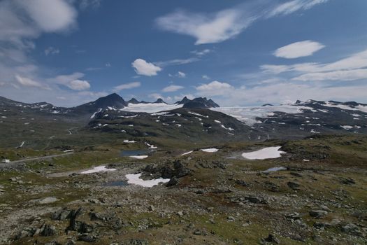 Panoramic view of snow-capped mountains and clear sky in Innlandet, Norway, perfect for nature enthusiasts.