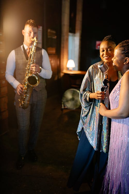 A Pair of Singers Singing with the Saxophone's Melody