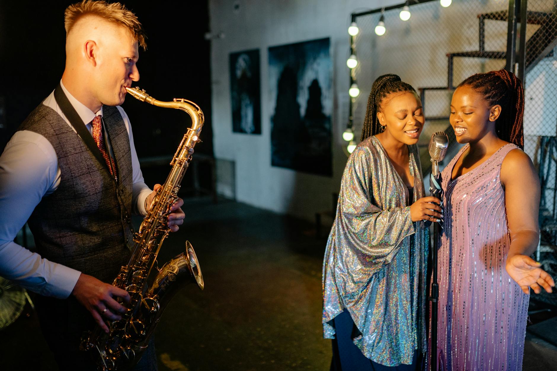 A group of musicians with saxophone and microphone performing indoors with elega
