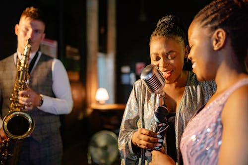 Women Singing and a Man Playing the Saxophone 