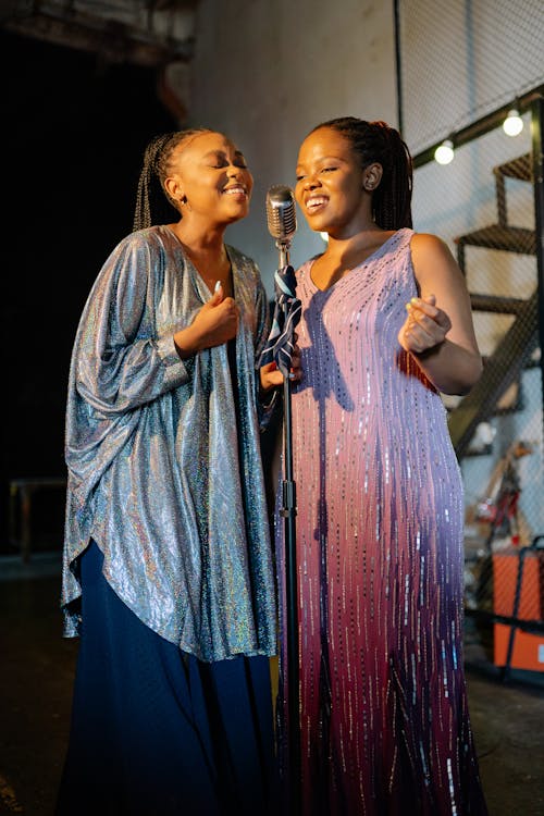 Beautiful Women Standing while Singing Together