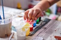 A Person Touching a Tub of Paint