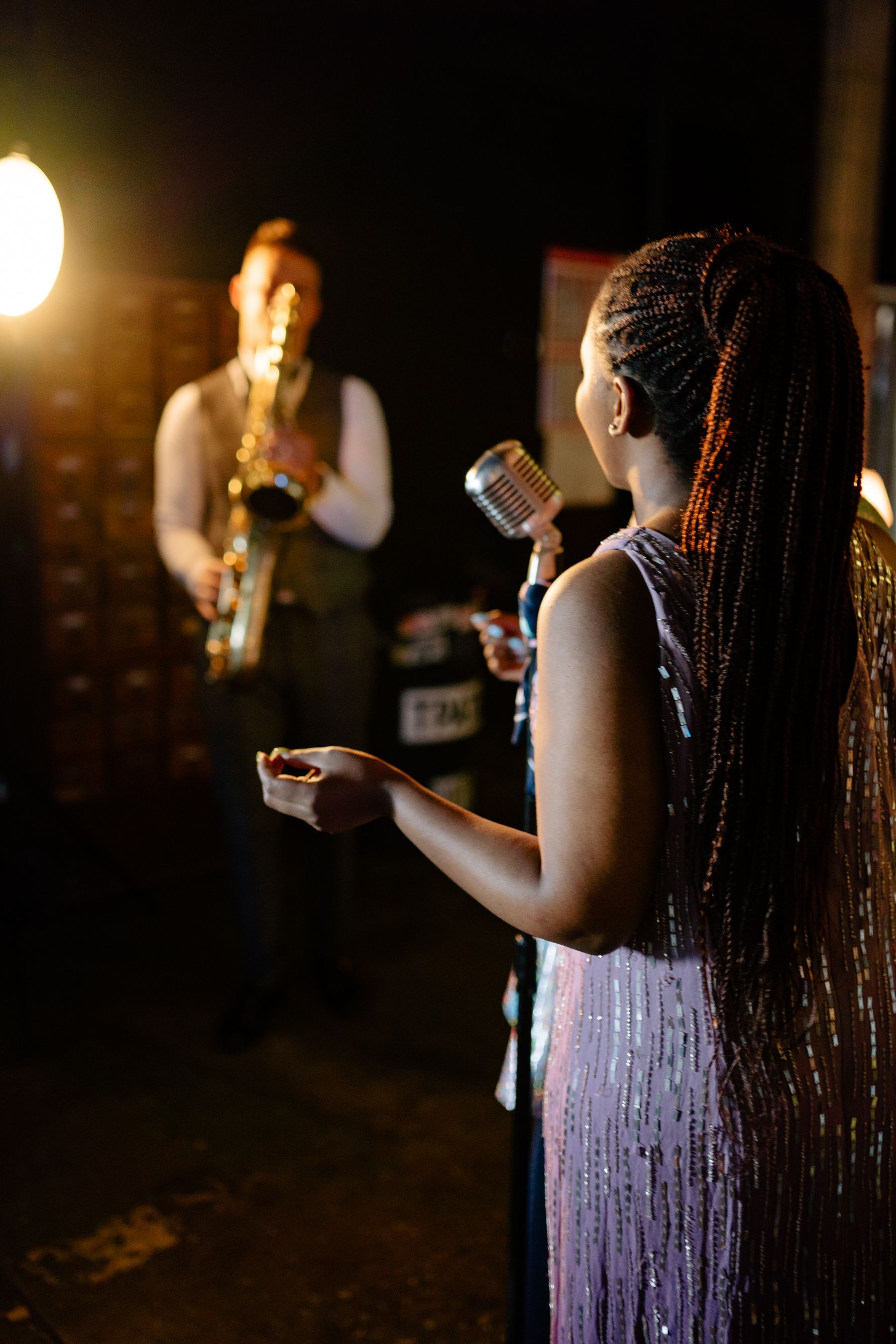 Singer and saxophonist performing live in an elegant nightclub