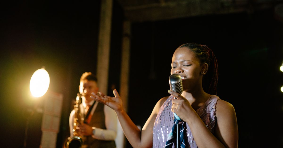 Boxie Singer A Singer and a Saxophonist Doing a Performance · Free Stock Photo