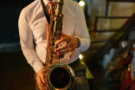 A musician in formal attire plays the saxophone indoors, showcasing musical talent.