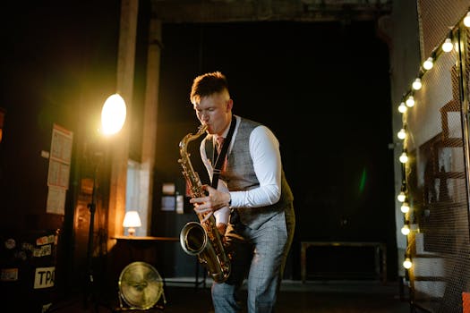 Musician plays saxophone in dimly lit room, creating moody jazz ambiance.