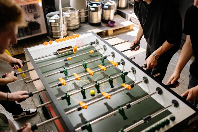 Men Playing Foosball