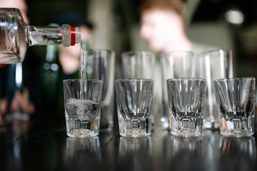 A Person Pouring Alcoholic Drink in a Glass