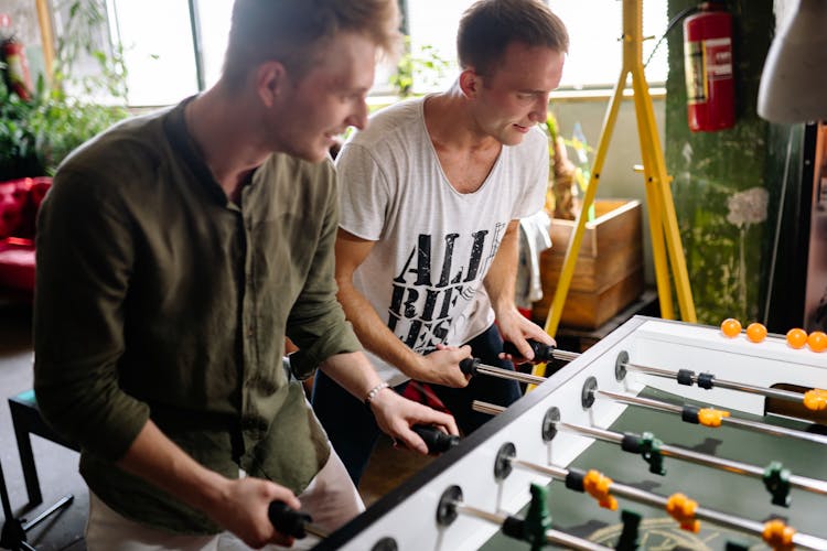 Two Men Playing Foosball