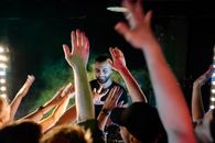 People Raising Their Hands during Nighttime