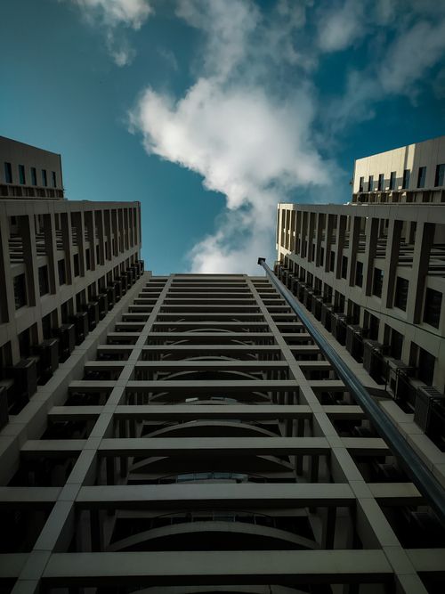 Free Low angle view of modern skyscraper buildings with a dramatic sky and clouds. Stock Photo
