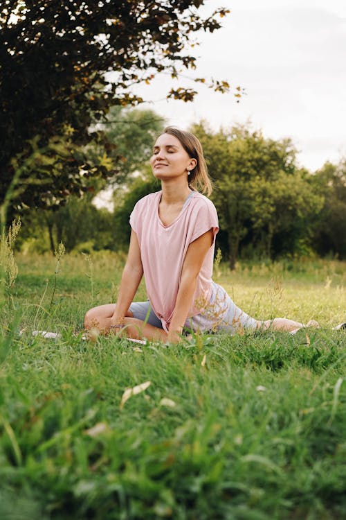 Woman with Eyes Closed Doing Yoga on the Park