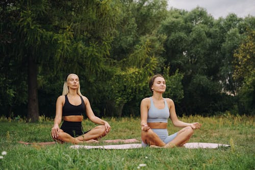 Woman Wearing Sport Bras Meditating on the Park