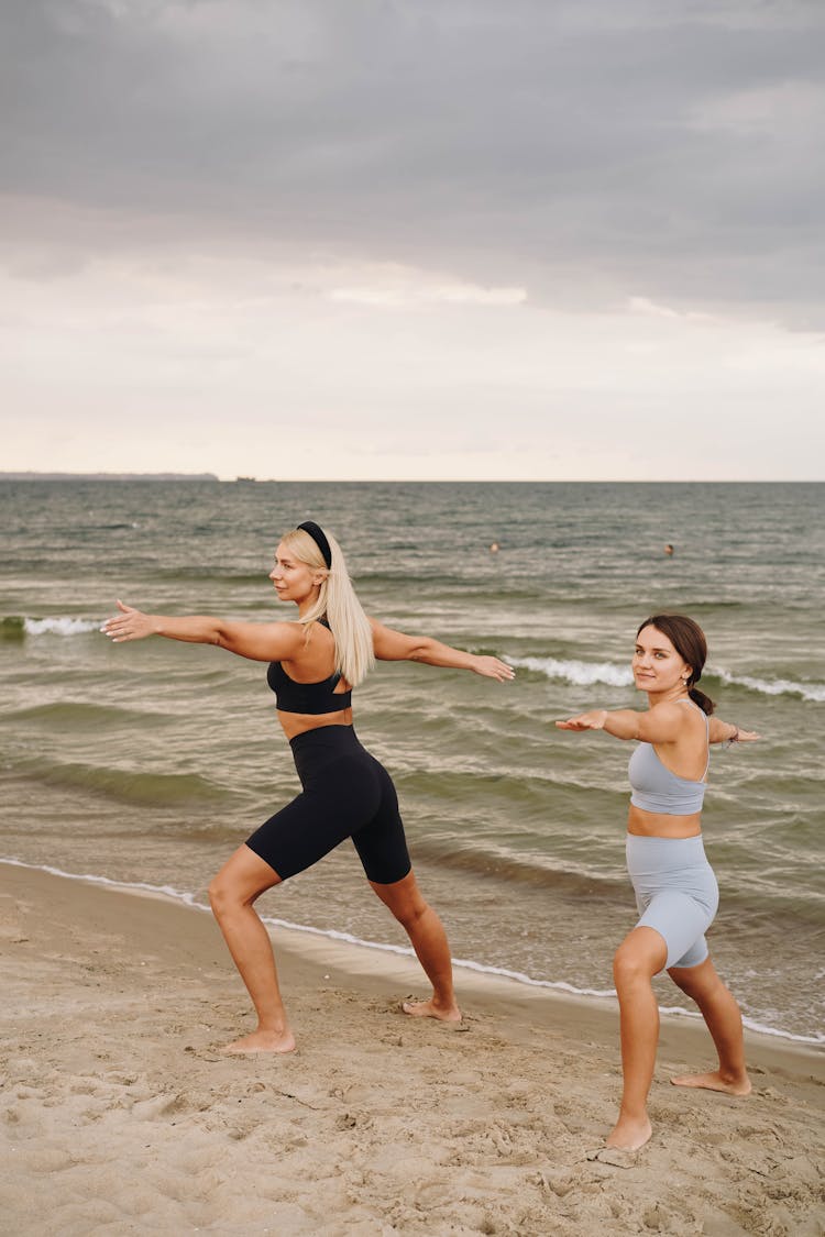 A Two Women Doing Workout On A Beach