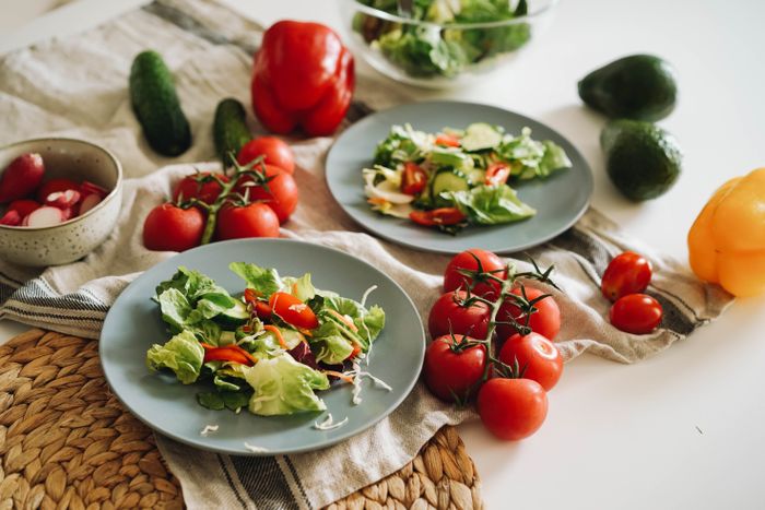 Overhead spread of fresh salad ingredients — photo by olia danilevich on Pexels