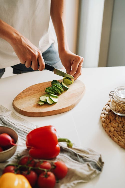 A Person Slicing a Cucumber 