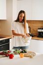 Woman in White T-shirt Holding White Metal Colander