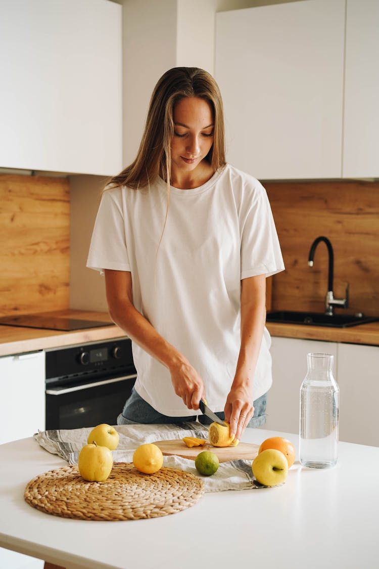 A Woman Slicing A Lemon