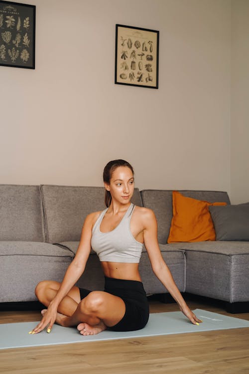 A Woman Sitting on a Yoga Mat 