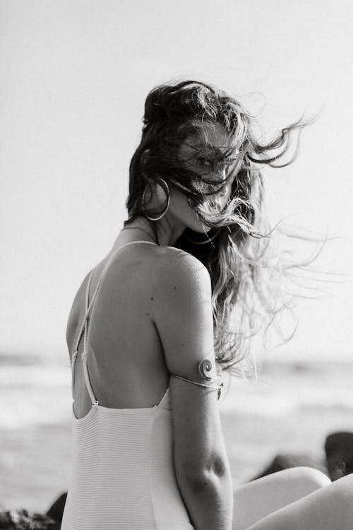 Grayscale Photo of a Woman in White Bikini Top