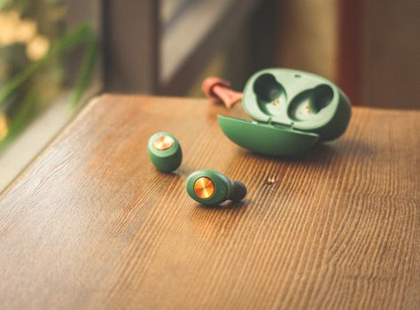 Green Earphones on Wooden Table