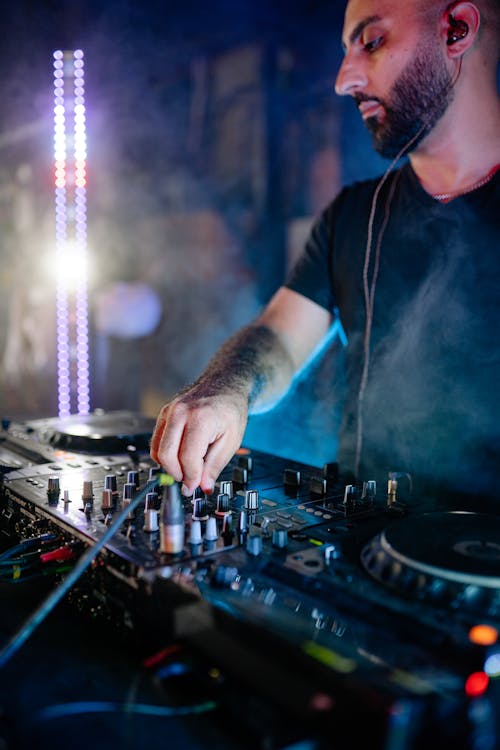 Free Man in Blue and Black Crew Neck T-shirt Playing Dj Mixer Stock Photo