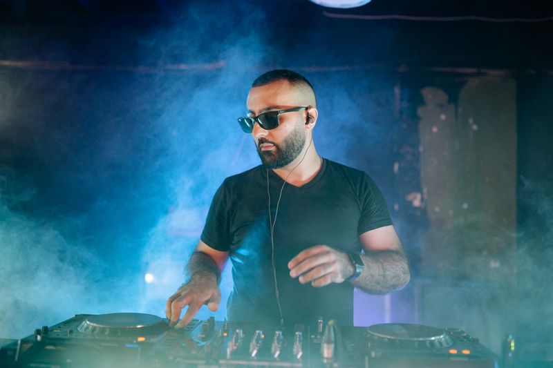 DJ working an audio mixer in the nightclub
