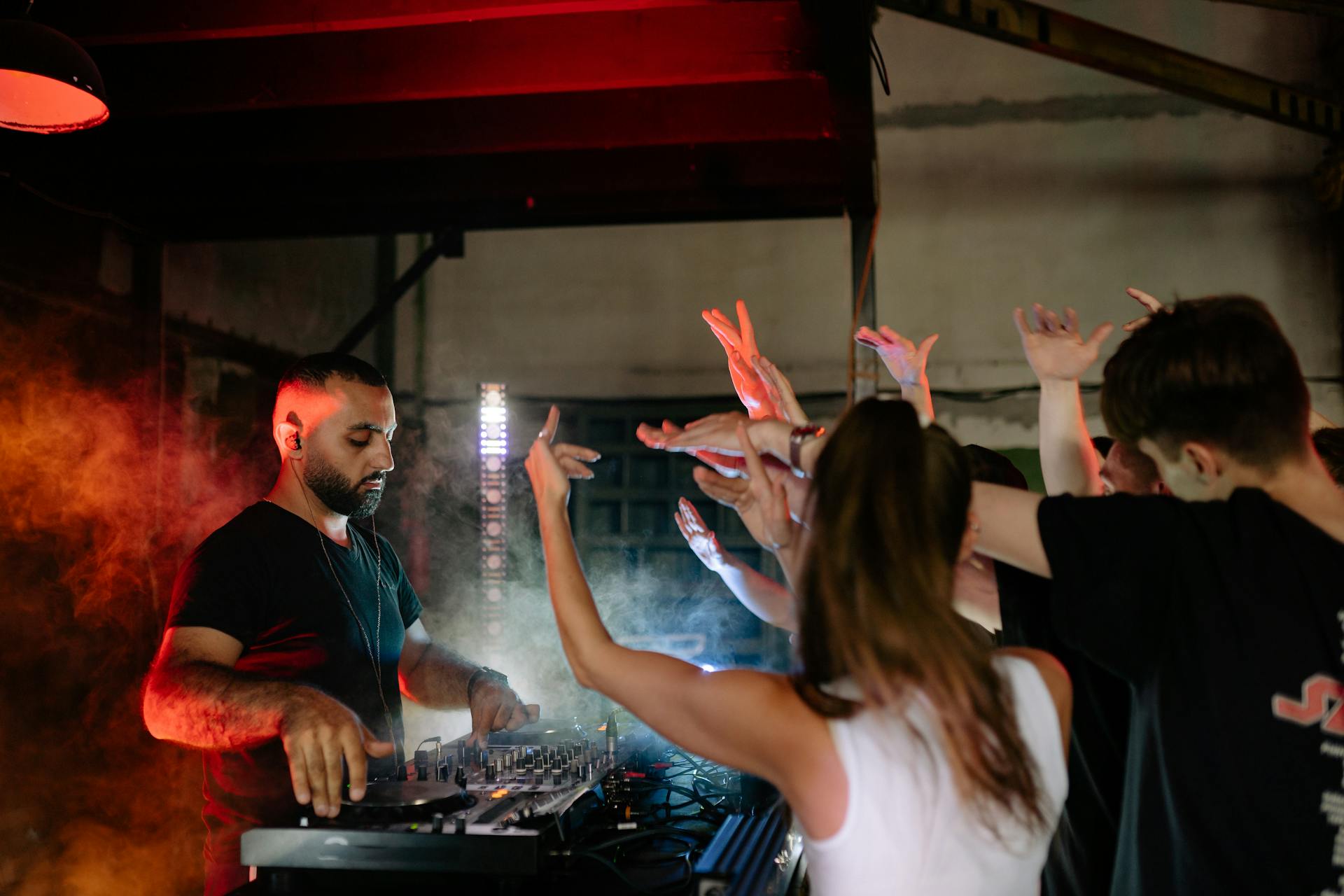 A Disc Jockey Playing Music in Front of the Crowd