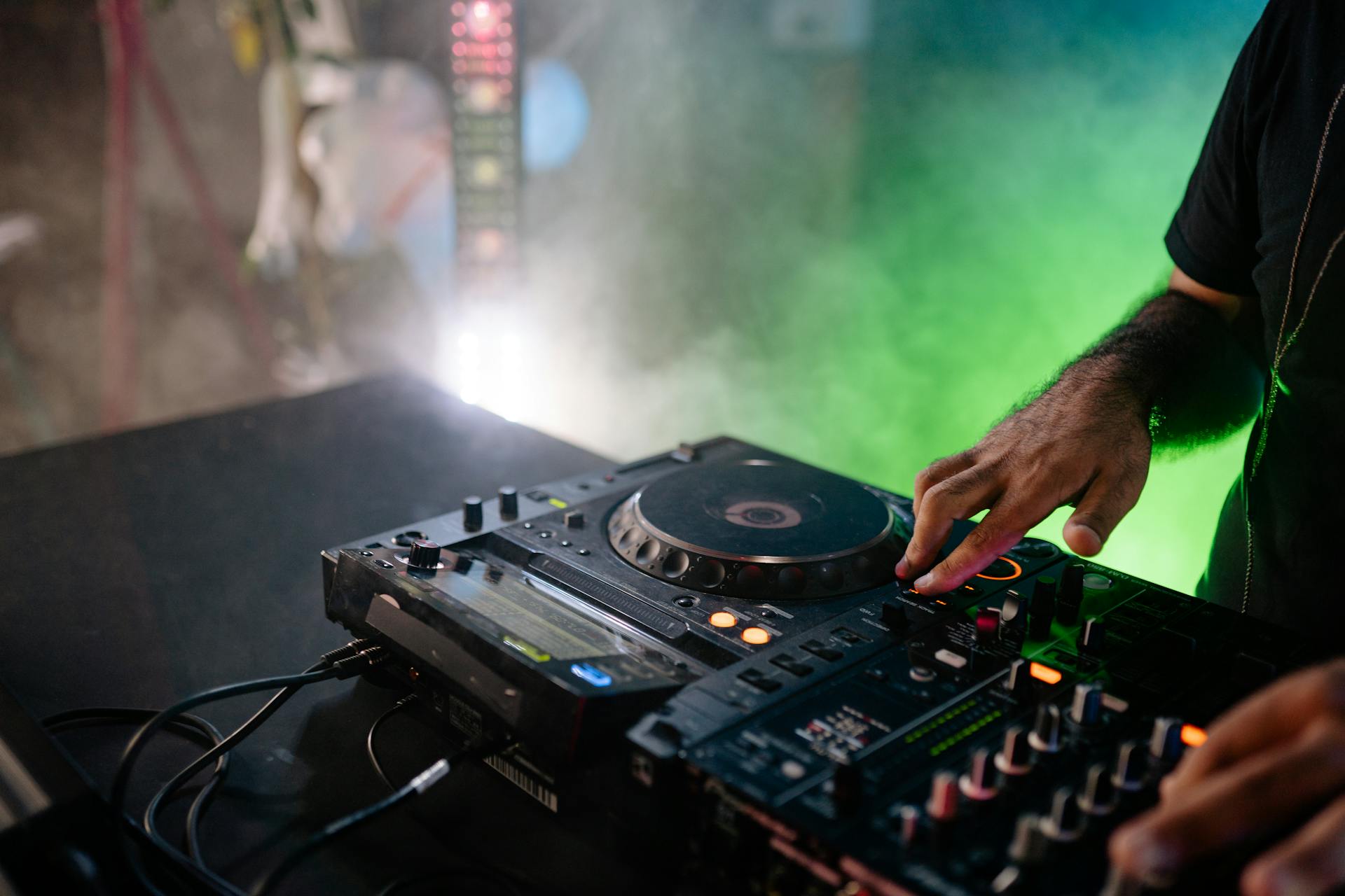 Person Playing Dj Mixer in a Room