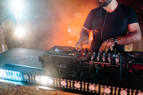 Man in Black Crew Neck T-shirt Playing Dj Mixer