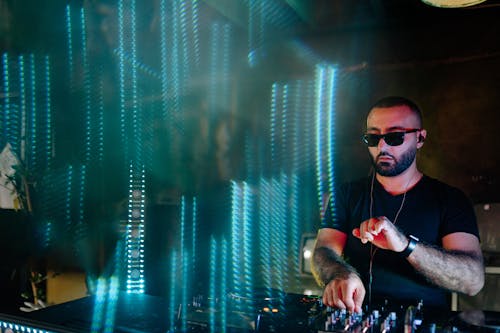 A Man in Black Sunglasses on a Nightclub