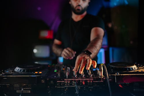 A Man Using an Audio Mixer