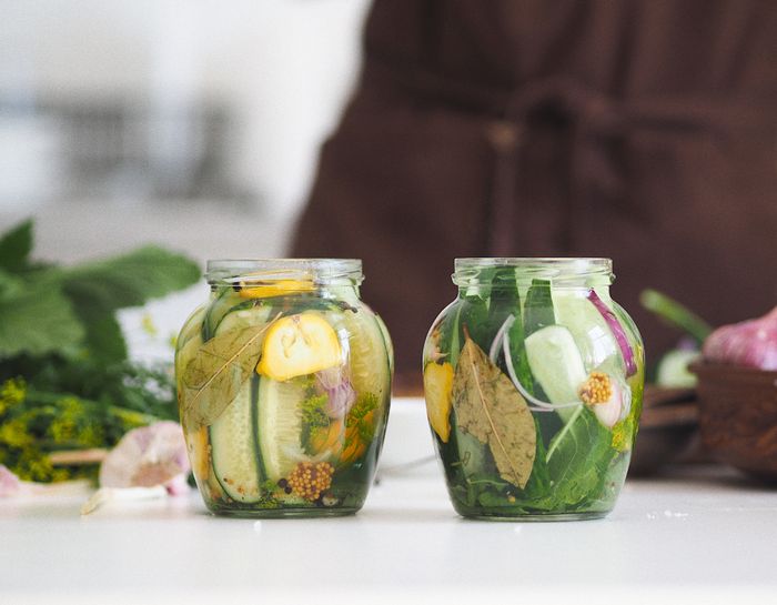 Two unlabelled glass jars of preserved vegetables — photo by Maria Verkhoturtseva on Pexels