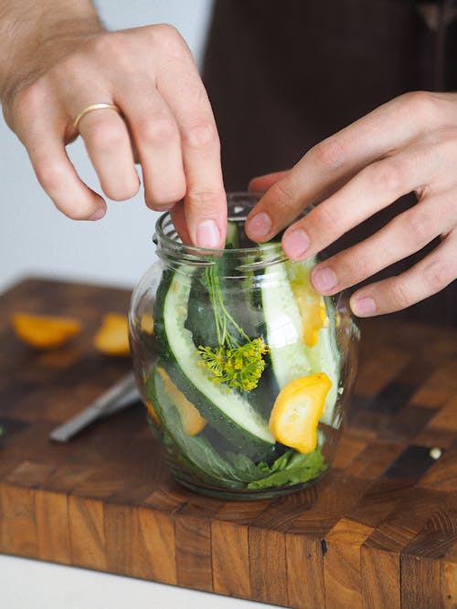 Unrecognizable Man Preparing Pickles of Courgette