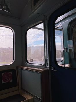 Interior of a train with a scenic outdoor view through large windows
