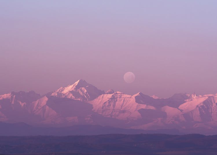 Moon Above Snow Capped Mountains