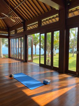 Serene yoga space with ocean view in Indonesia, perfect for relaxation and meditation.
