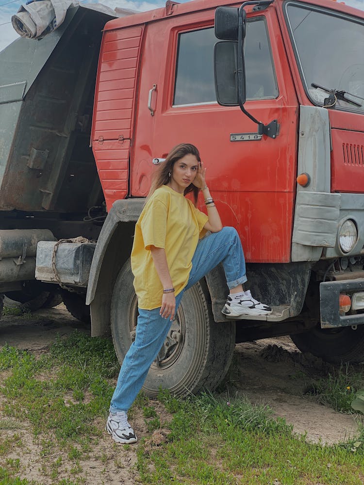 Woman In Yellow Oversize T-Shirt Standing Beside Red Truck