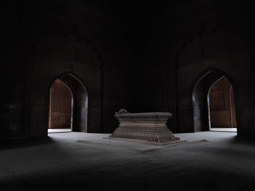 Dimly lit interior of Safdarjung Tomb, showcasing its architectural grandeur in New Delhi, India.