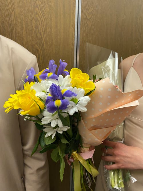 A Person Holding a Bouquet of Flowers